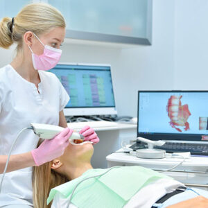 a patient gets her teeth digitally scanned